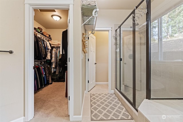 bathroom with tile patterned floors and an enclosed shower