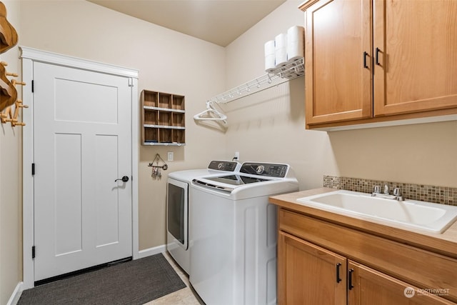 laundry area with washer and dryer, tile patterned floors, cabinets, and sink