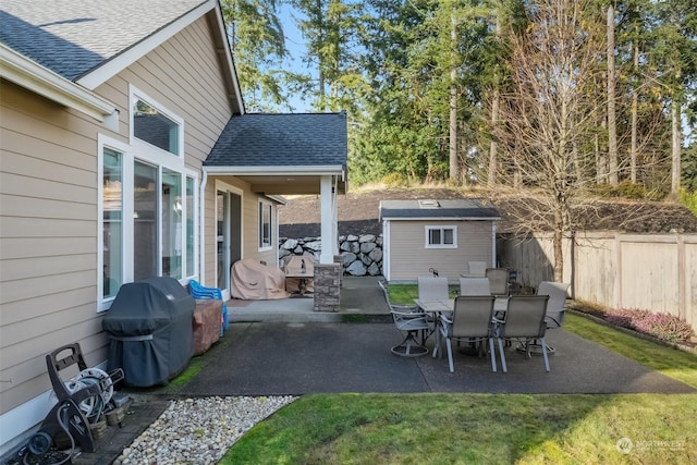 view of patio featuring a shed and area for grilling