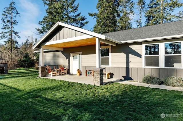 back of property featuring a yard and a patio