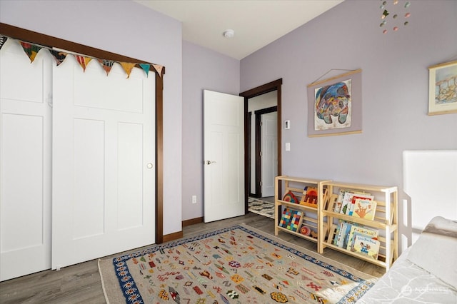 bedroom with a closet and dark wood-type flooring