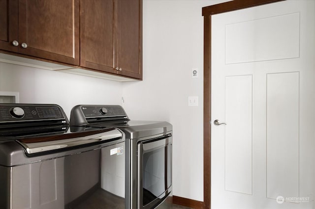 laundry room featuring cabinets and separate washer and dryer