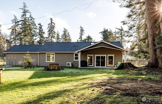 back of property featuring ac unit and a lawn