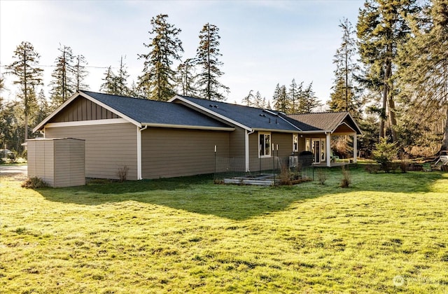 rear view of house featuring a lawn