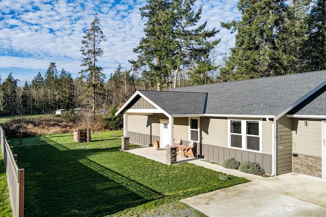 ranch-style house with a patio area and a front lawn