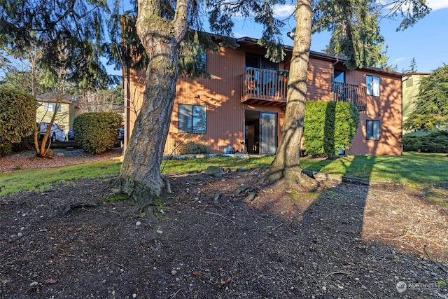 rear view of property with a balcony