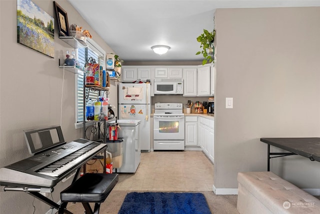 kitchen with white appliances and white cabinetry