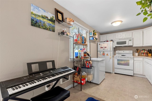 kitchen with white cabinetry and white appliances