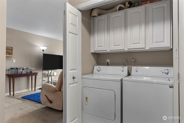 washroom with light carpet, washer and clothes dryer, and cabinets