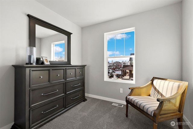 living area with dark carpet and a wealth of natural light