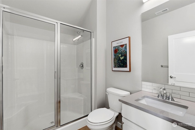 bathroom with walk in shower, decorative backsplash, vanity, and toilet