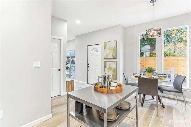 dining area with a chandelier and light wood-type flooring