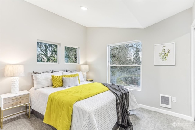 bedroom with carpet floors, multiple windows, and lofted ceiling