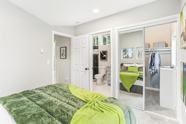 bedroom with light colored carpet and a closet