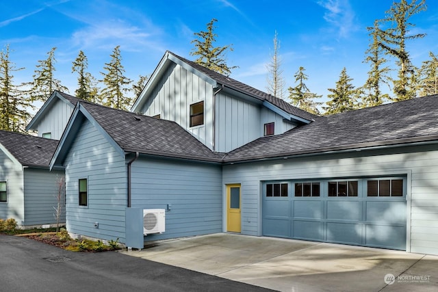 view of front of property featuring ac unit and a garage