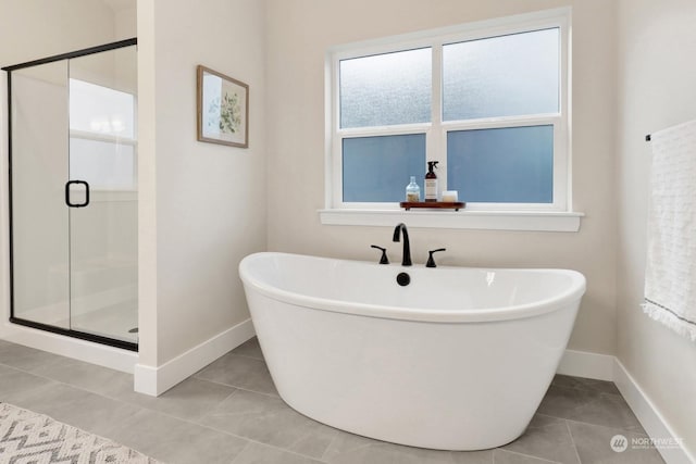 bathroom featuring tile patterned flooring and separate shower and tub