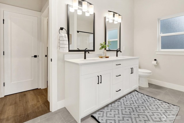 bathroom featuring tile patterned flooring, vanity, and toilet