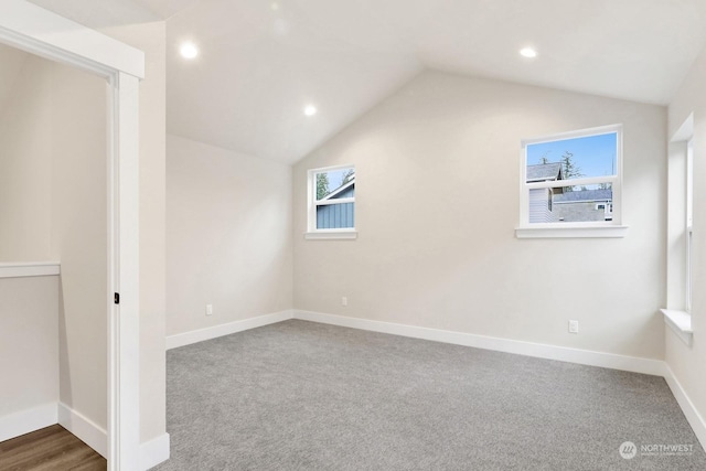 bonus room with carpet flooring and lofted ceiling