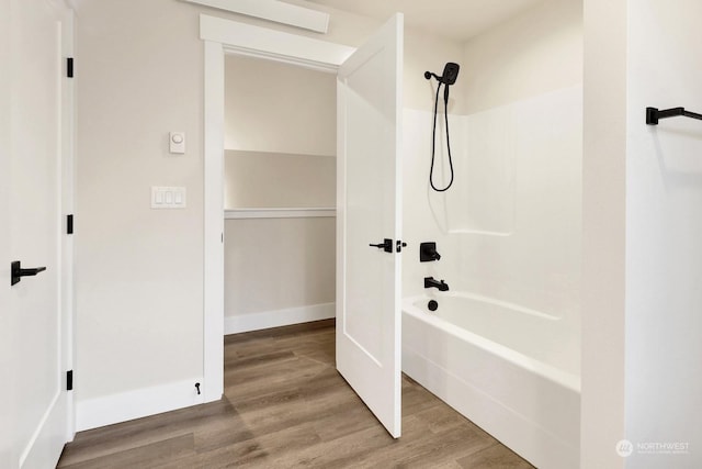 bathroom with shower / bathing tub combination and wood-type flooring