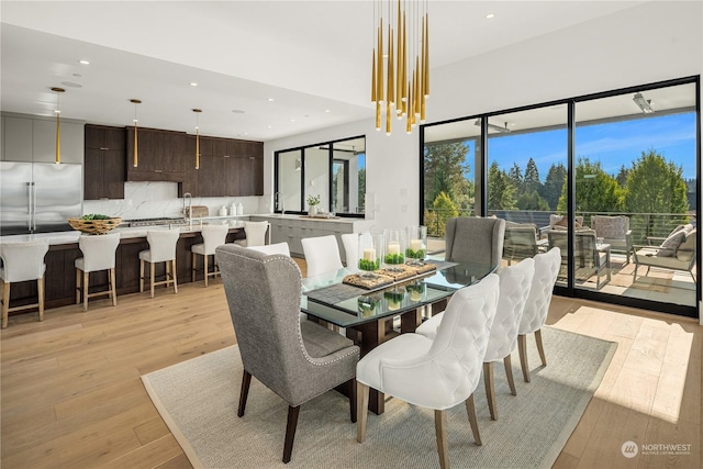 dining area featuring light hardwood / wood-style flooring and an inviting chandelier