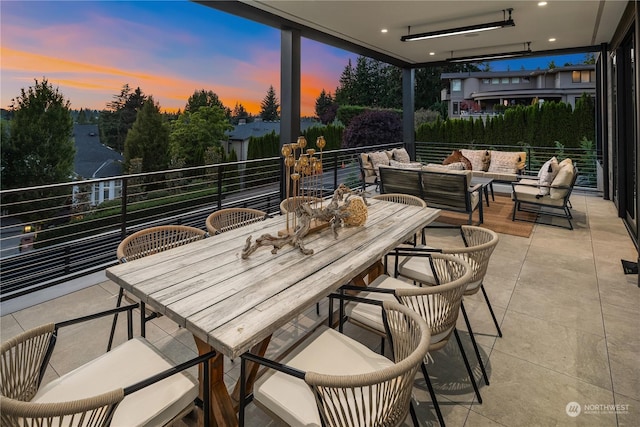 patio terrace at dusk featuring an outdoor living space