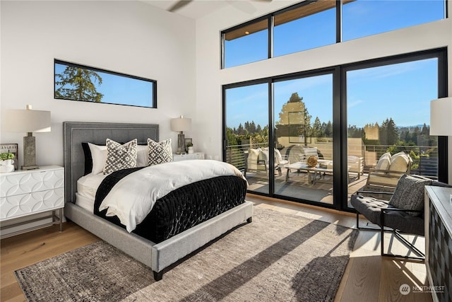 bedroom featuring access to exterior and wood-type flooring