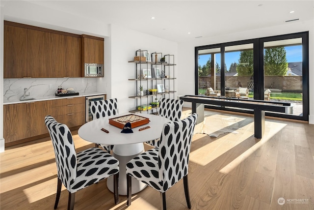 dining area featuring light hardwood / wood-style floors and sink