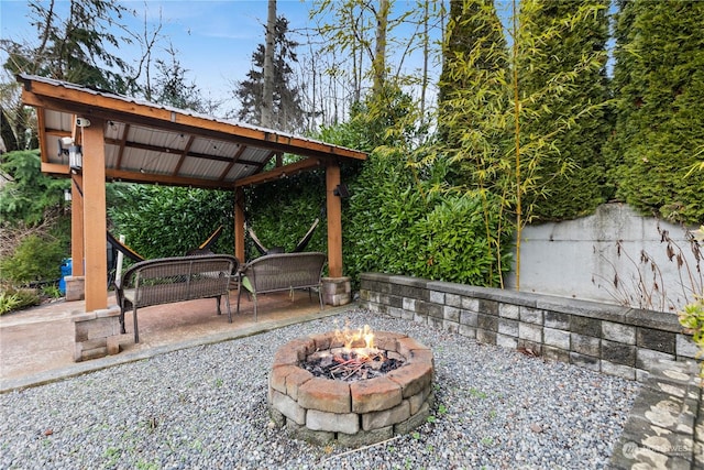 view of patio / terrace with a gazebo and a fire pit