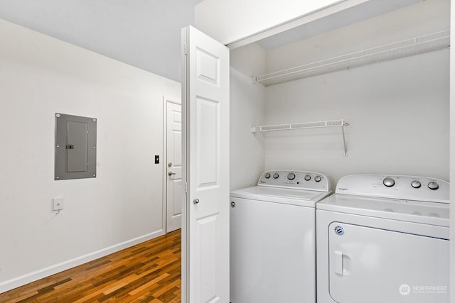 washroom with electric panel, dark hardwood / wood-style flooring, and washer and dryer