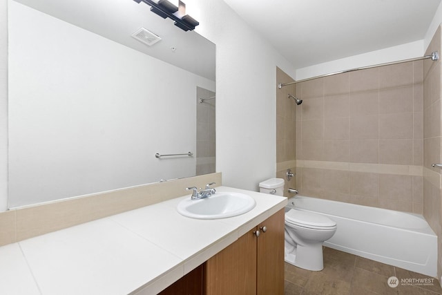 full bathroom featuring vanity, toilet, and tiled shower / bath