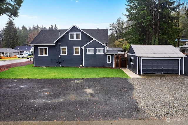 front of property with a front lawn, an outdoor structure, and a garage