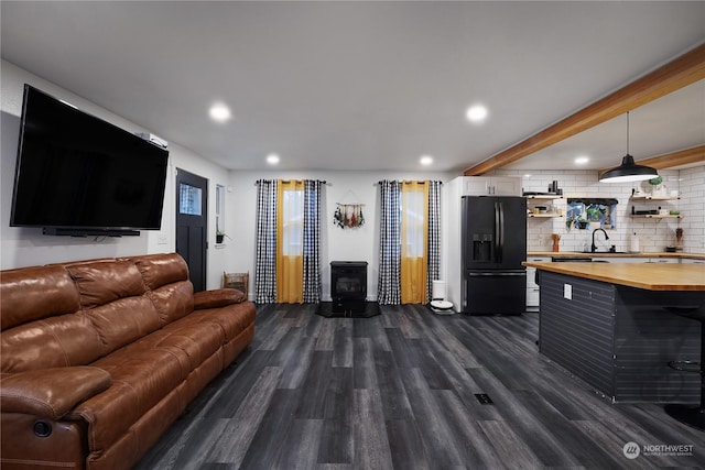 living room featuring dark hardwood / wood-style floors and sink