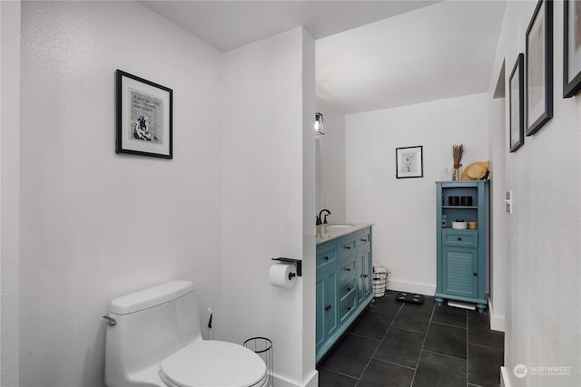 bathroom with tile patterned flooring, vanity, and toilet