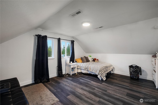 bedroom featuring dark hardwood / wood-style floors and lofted ceiling