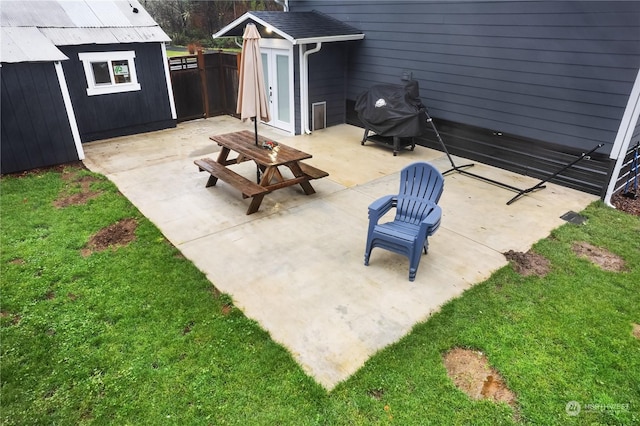 view of patio / terrace featuring a grill and a shed