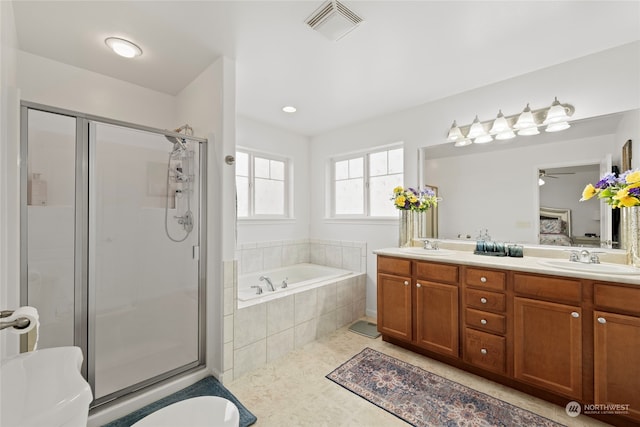 bathroom featuring visible vents, a sink, a shower stall, and a bath