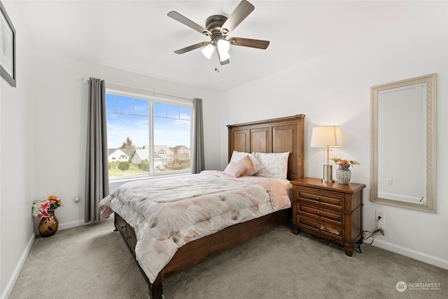 bedroom featuring light carpet, ceiling fan, and baseboards