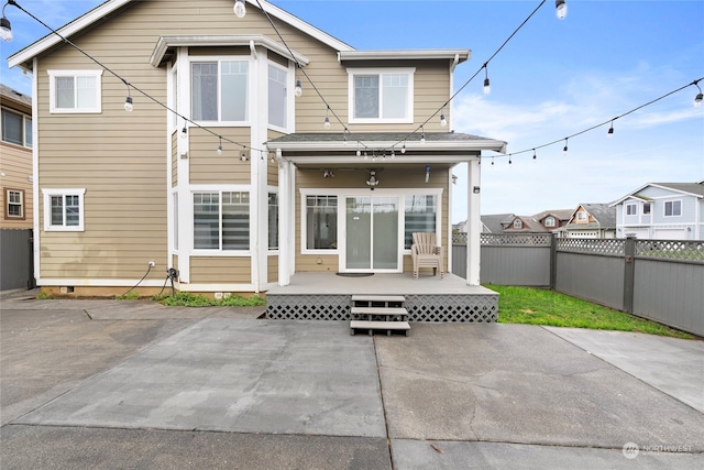 rear view of house with fence and a patio