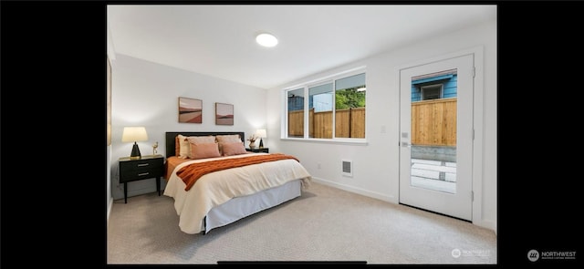 carpeted bedroom featuring access to exterior