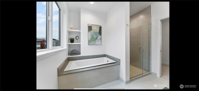 bathroom featuring plus walk in shower and tile patterned floors