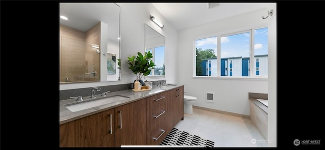 bathroom featuring toilet and vanity