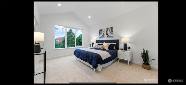 bedroom featuring lofted ceiling and light carpet