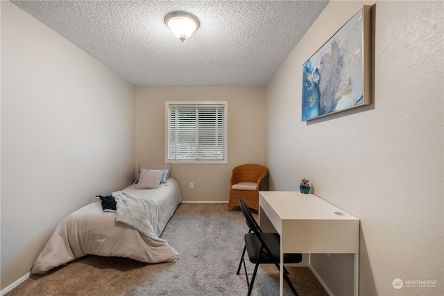 bedroom featuring light colored carpet and a textured ceiling