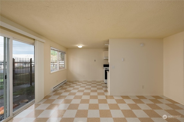 empty room with a baseboard heating unit and a textured ceiling