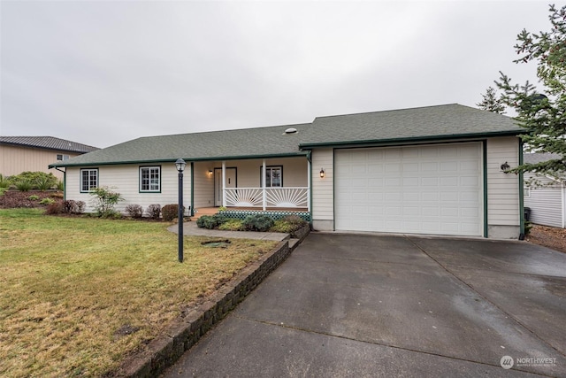 ranch-style house featuring covered porch, a garage, and a front lawn