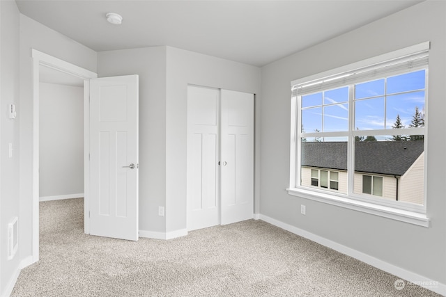 unfurnished bedroom with carpet and a closet