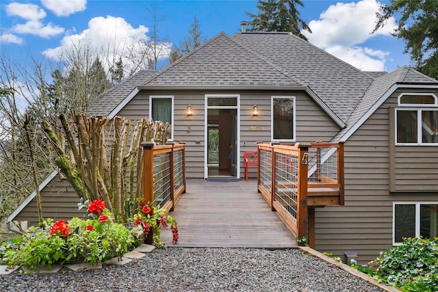 back of property featuring a wooden deck