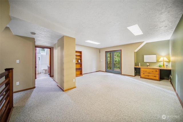 interior space featuring a textured ceiling and light carpet