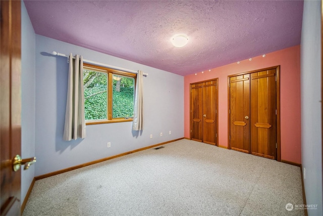 unfurnished bedroom with carpet floors and a textured ceiling