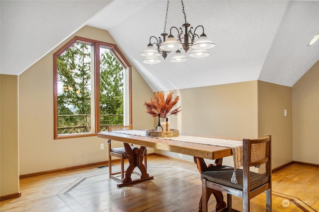 dining area with a chandelier, light hardwood / wood-style floors, and lofted ceiling